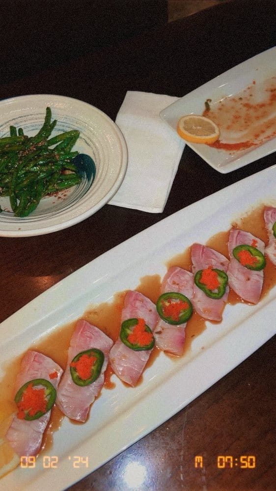 Yellowtail jalapeño sashimi with a side of sesame green beans